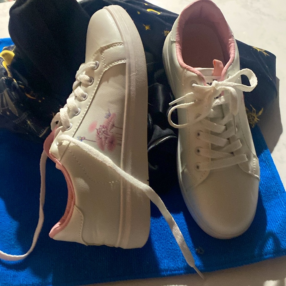 Brand new never been worn white sneakers. Pink inner interior flowers on sides.